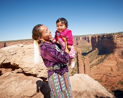 Photograph of woman and child in American Indian clothing.